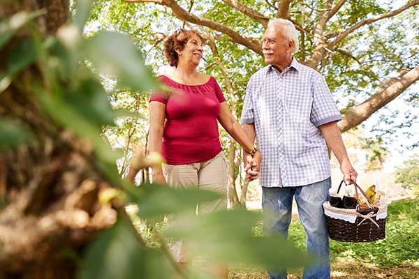 Older couple on a picnic - Cash cancer policies